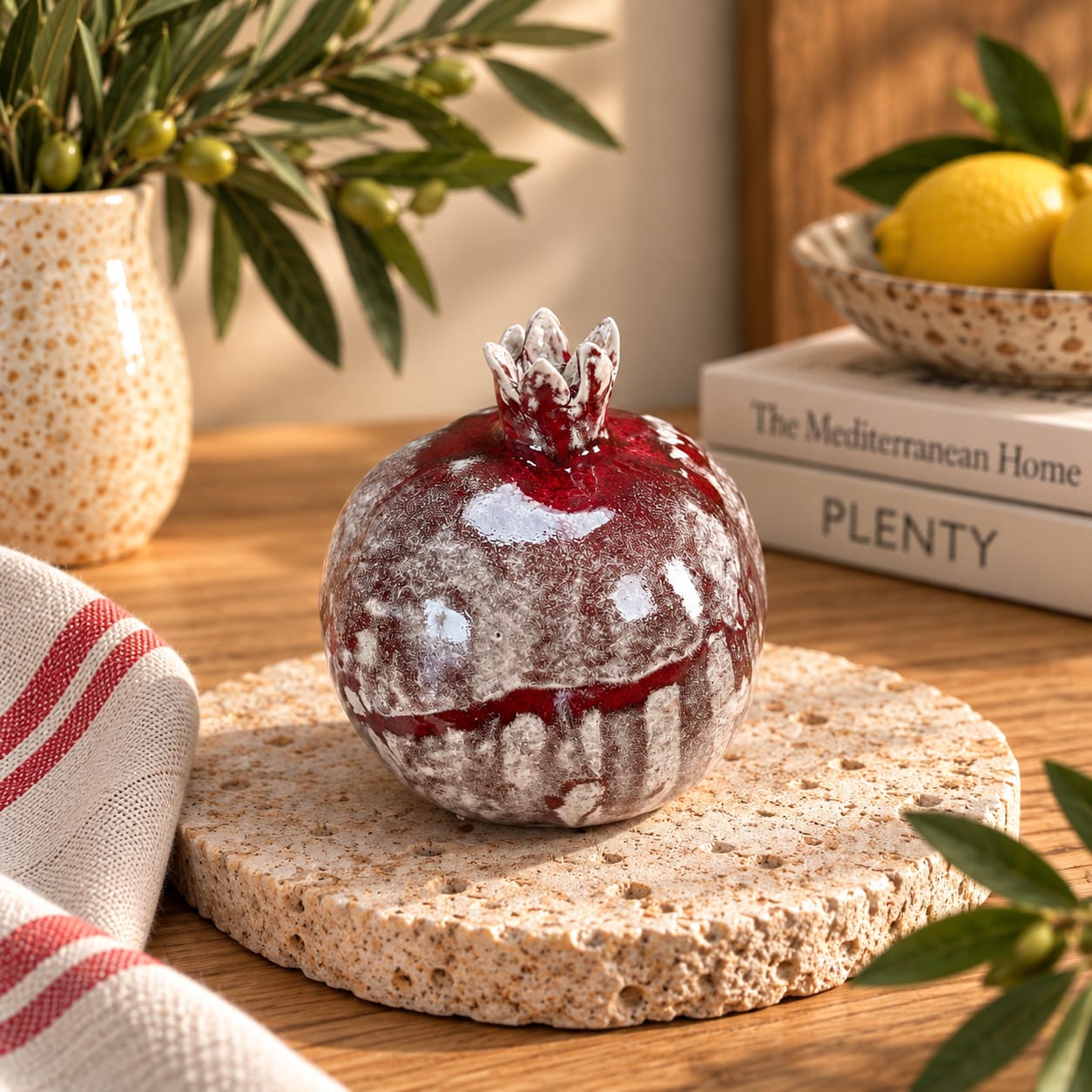 Large handmade ceramic pomegranate in red and white glaze. A unique decorative pottery sculpture symbolising love, abundance and new beginnings.