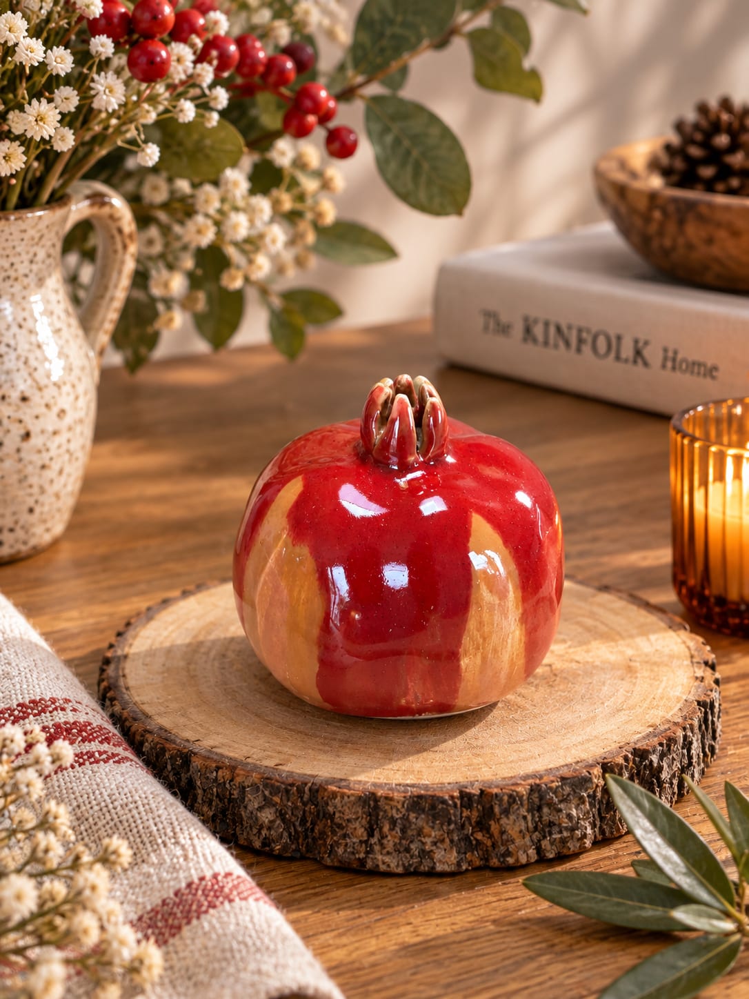 Handmade red ceramic pomegranate with a glossy red and earthy glaze. Unique decorative pottery symbolising love, abundance and new beginnings.