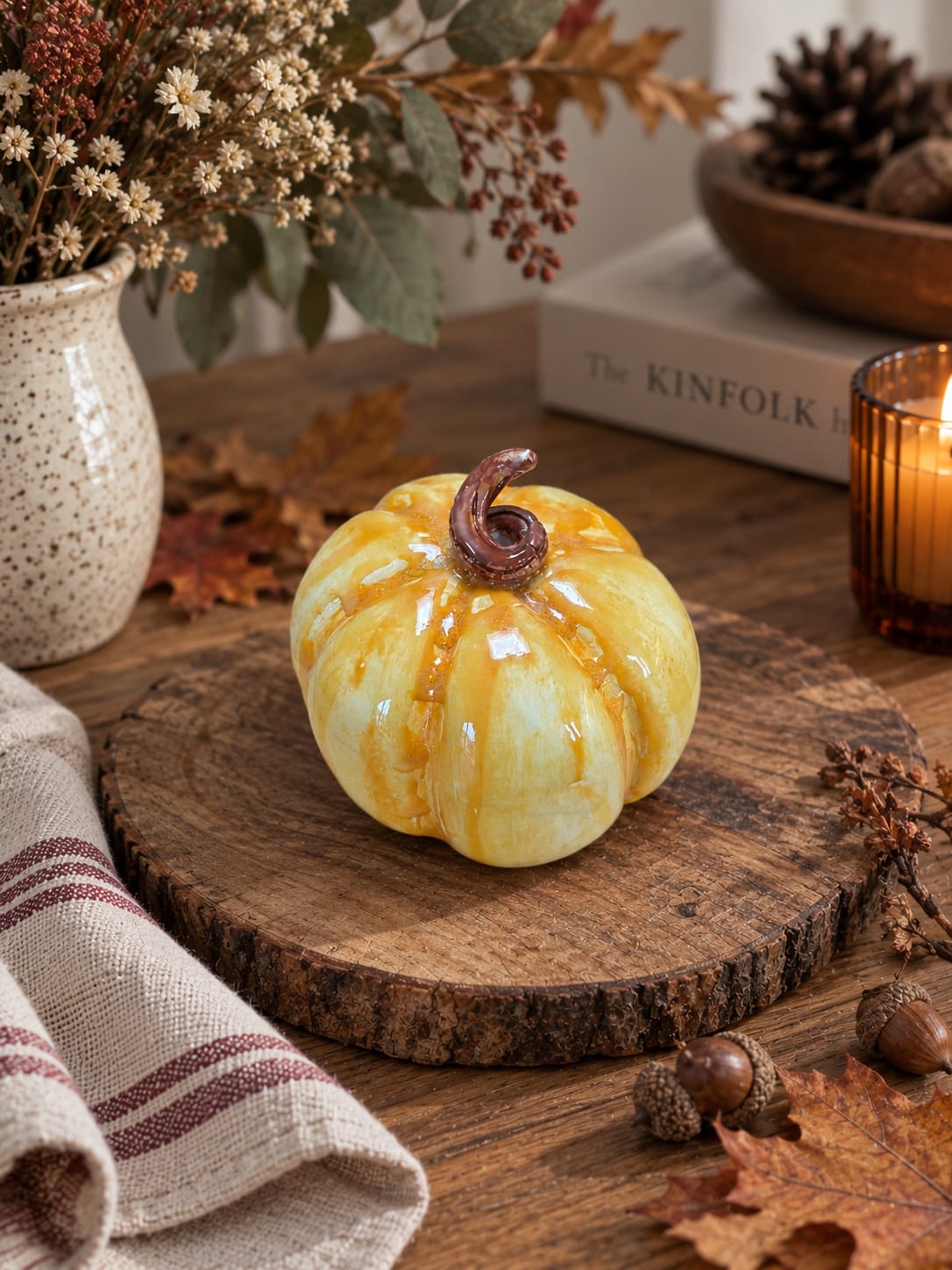 Handmade yellow ceramic pumpkin with a glossy golden glaze and curled stem. Unique autumn home decor and a charming handmade seasonal gift.