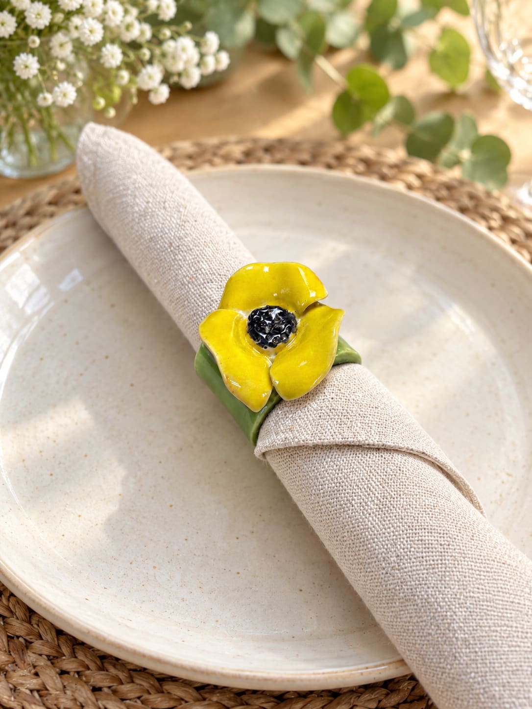 Set of four handmade yellow flower ceramic napkin rings with green bands