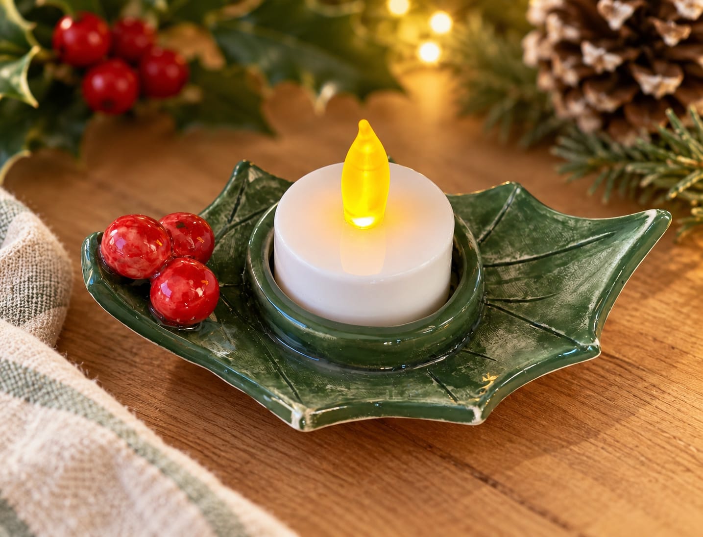 Handmade green ceramic holly tealight holder with red berries and candle