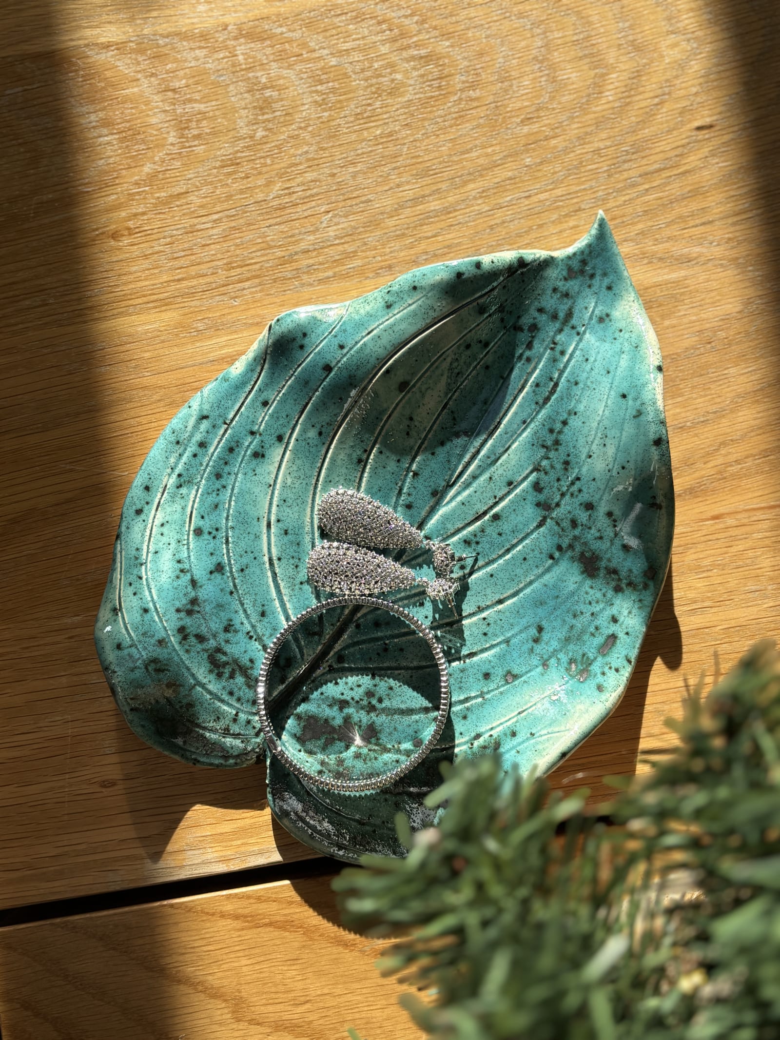 Turquoise ceramic leaf-shaped dish with hand-carved vein details and speckled glaze, botanical form