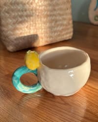 Side view showing the sculpted lemon on the turquoise handle
