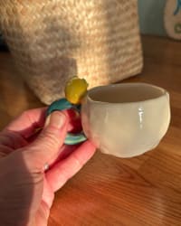 Mug filled with coffee showing the cream body and handle colour