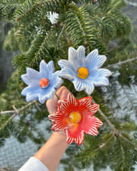 Set of three colourful ceramic flowers on green metal stems, each individually sculpted and hand-glazed