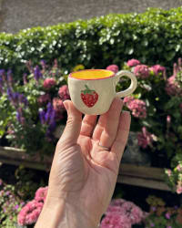 Interior view showing the bright yellow glazed inside of the espresso cup
