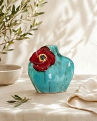 Small turquoise glazed ceramic bud vase with a hand-sculpted red flower on the front, 13cm tall