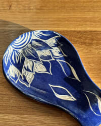 Handmade blue floral ceramic spoon rest with cream botanical leaf and flower design