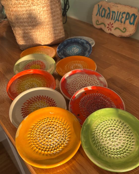 Round ceramic grater plate with textured grating surface and colourful hand-painted glaze, 13cm diameter