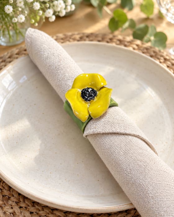 Set of four handmade yellow flower ceramic napkin rings with green bands