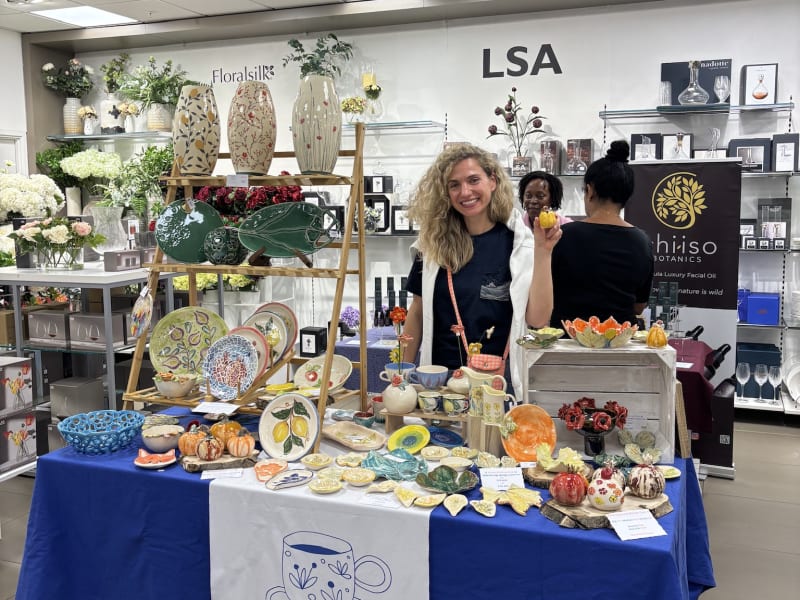 A quiet artisan market stall with InchyArt handmade ceramics on display