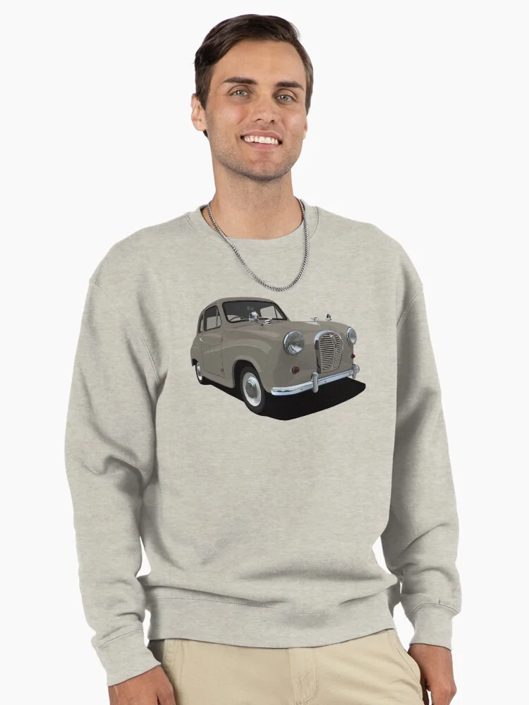 A man wearing a light grey sweatshirt with a graphic of a grey Austin A35 on the front.