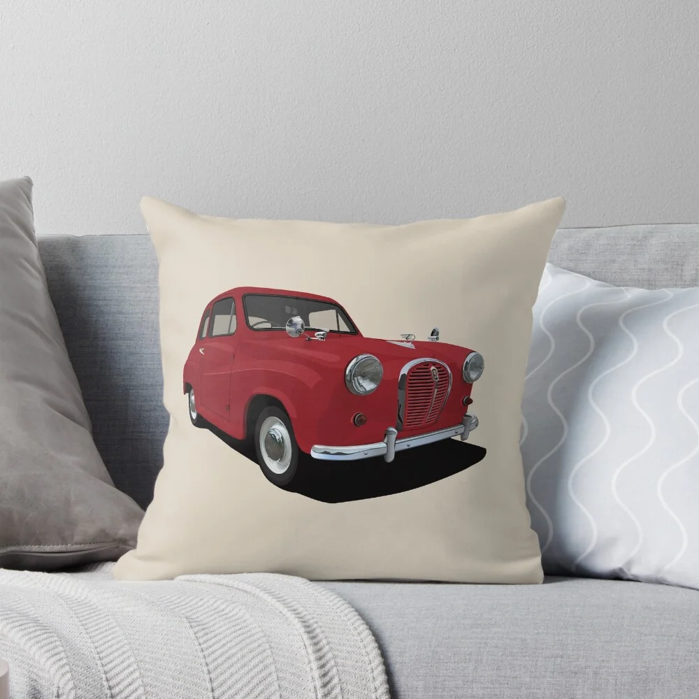 A throw pillow with a graphic of a red Austin A35 on a cream background, displayed on a sofa.