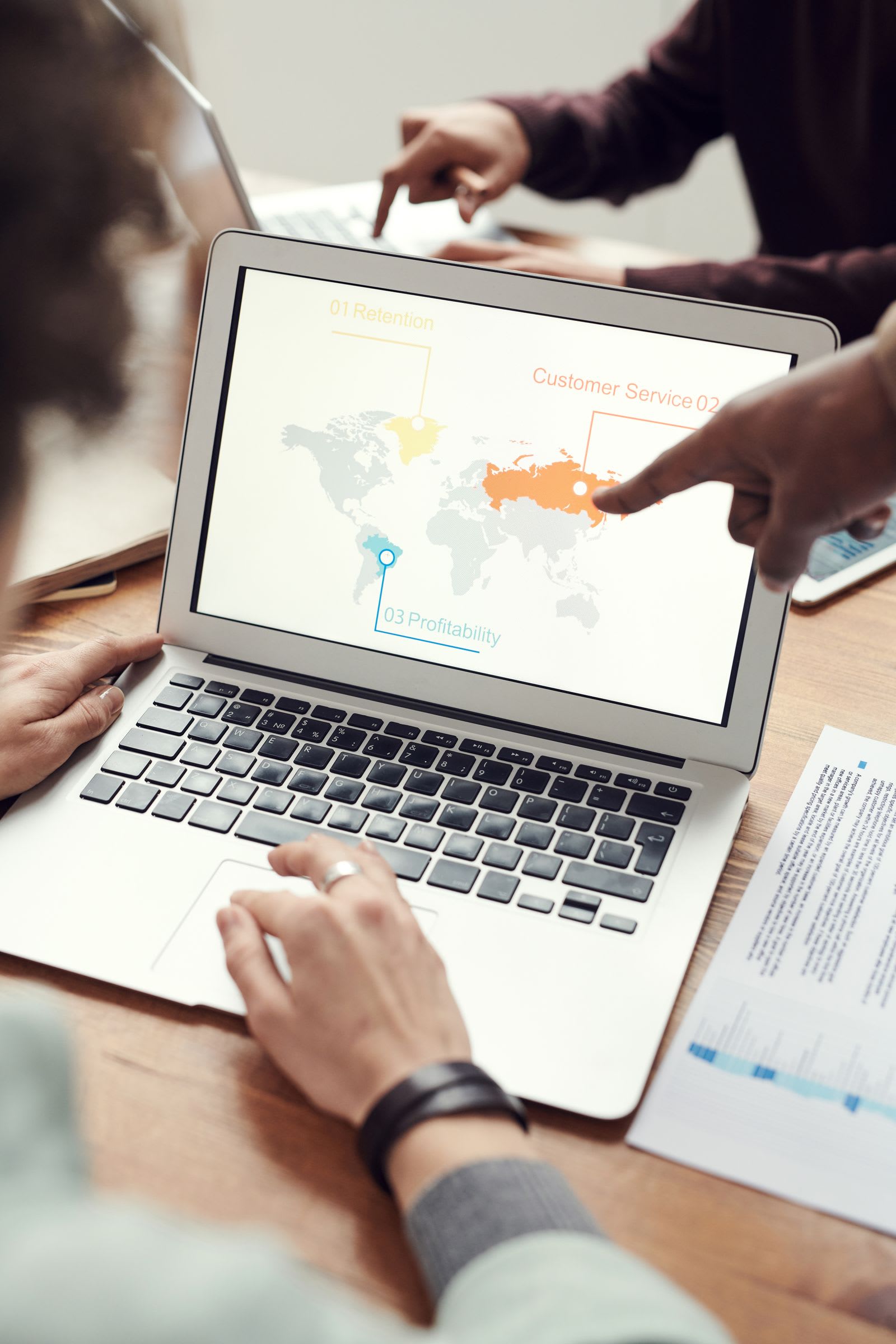 Team reviewing a global coverage map on a laptop during a planning session