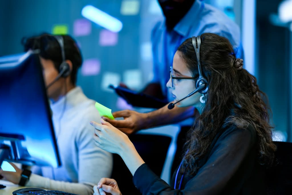 Support team collaborating in a production operations workspace