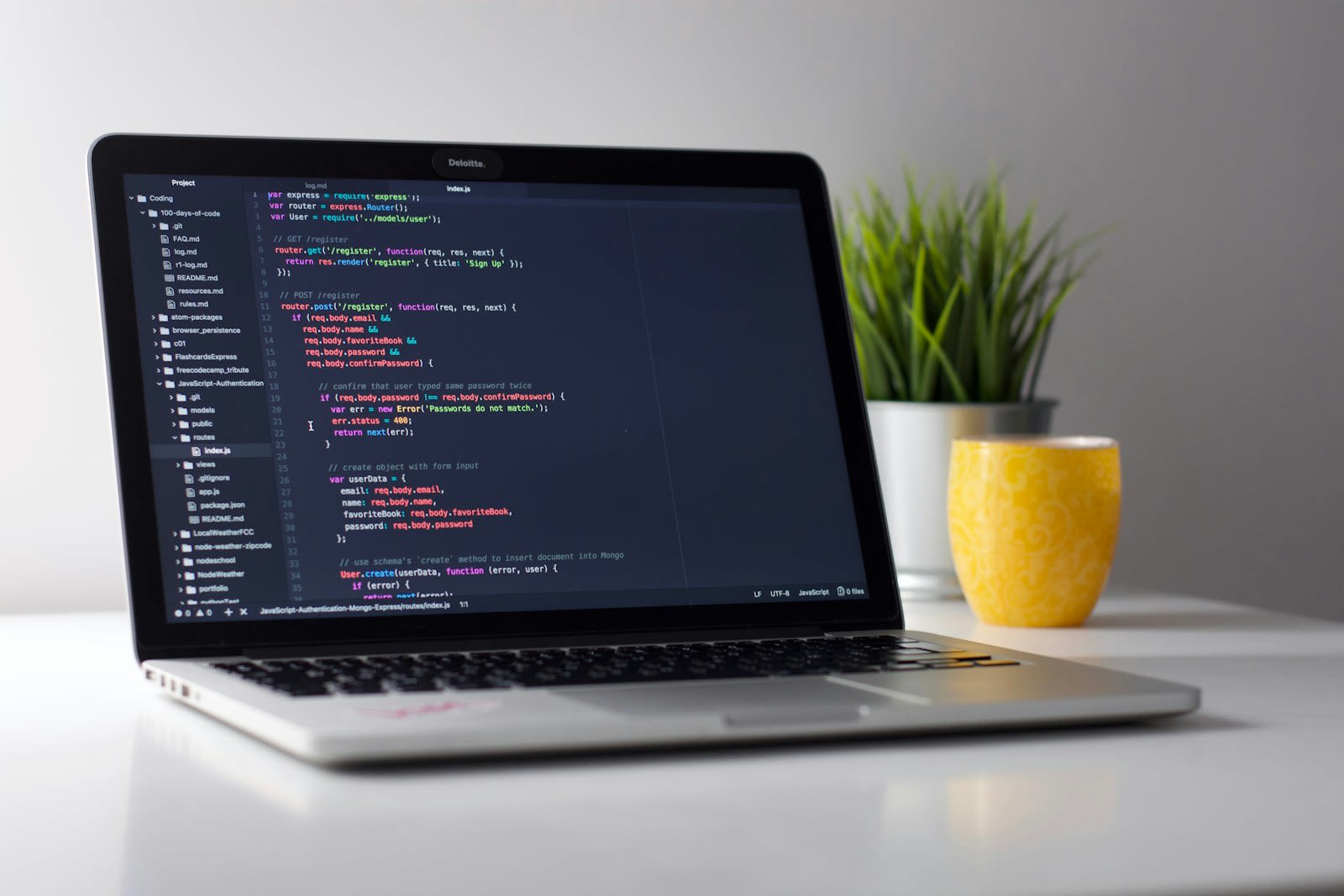 Developer workstation with application code and authentication routes open in the editor