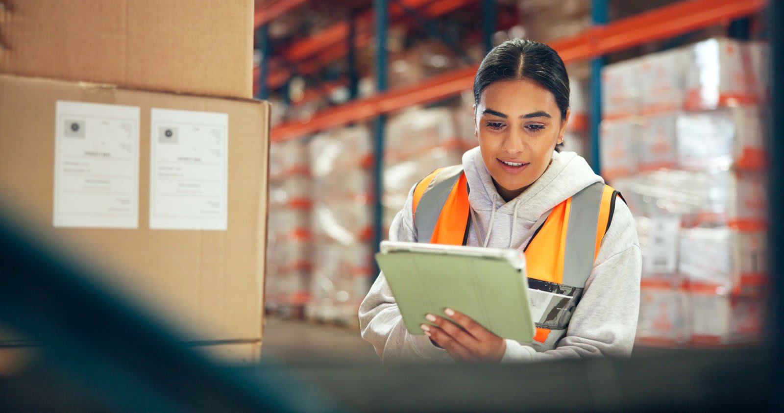 Warehouse operations specialist using a tablet for inventory and supply-chain work