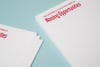 Closeup of corners of two stacks of school letterheads