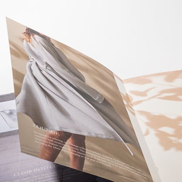 Saddle-stitched booklet with pages fanned open
