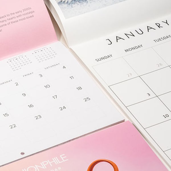 Laid open saddle stitched calendars side by side 