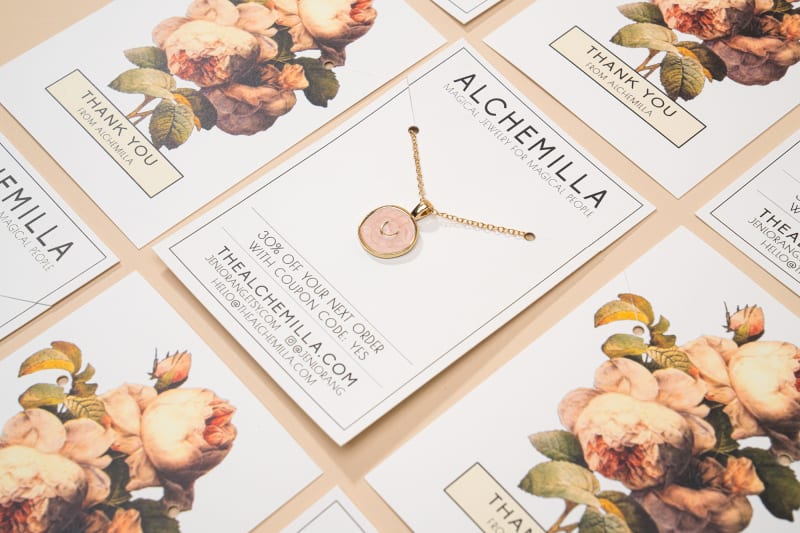 Necklace card with attached necklace surrounded by more cards