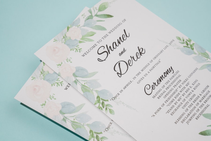 Close up of corner of stack of wedding programs