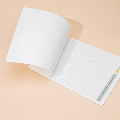 Graph paper notepad with one page lifted
