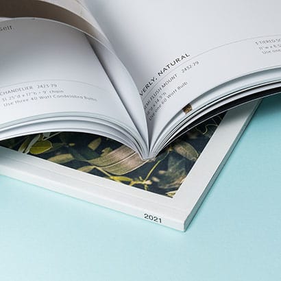 Perfect bound magazine with pages fanned open on top of closed magazine