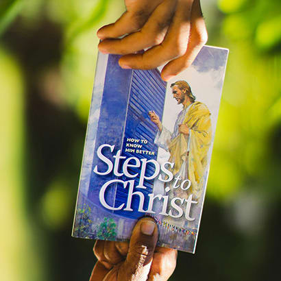 A church brochure passing from one hand to another
