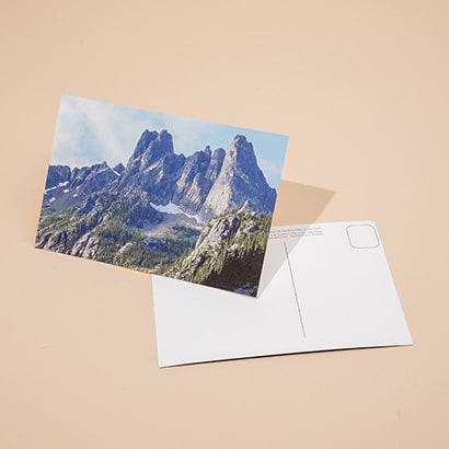 Front and back of a postcard with a mountain on it