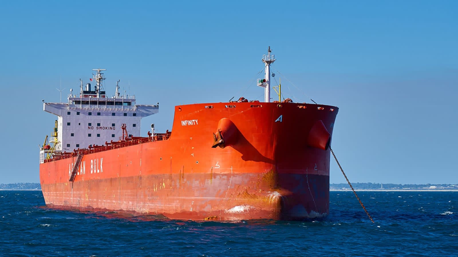 cargo ship at sea at dusk with lights on (file image)
