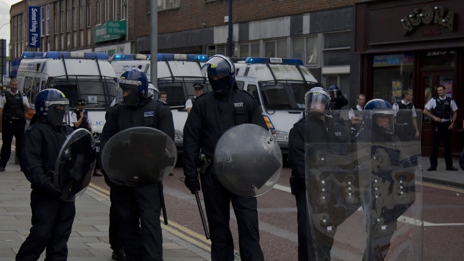riot police vans parked on a city street (file image)