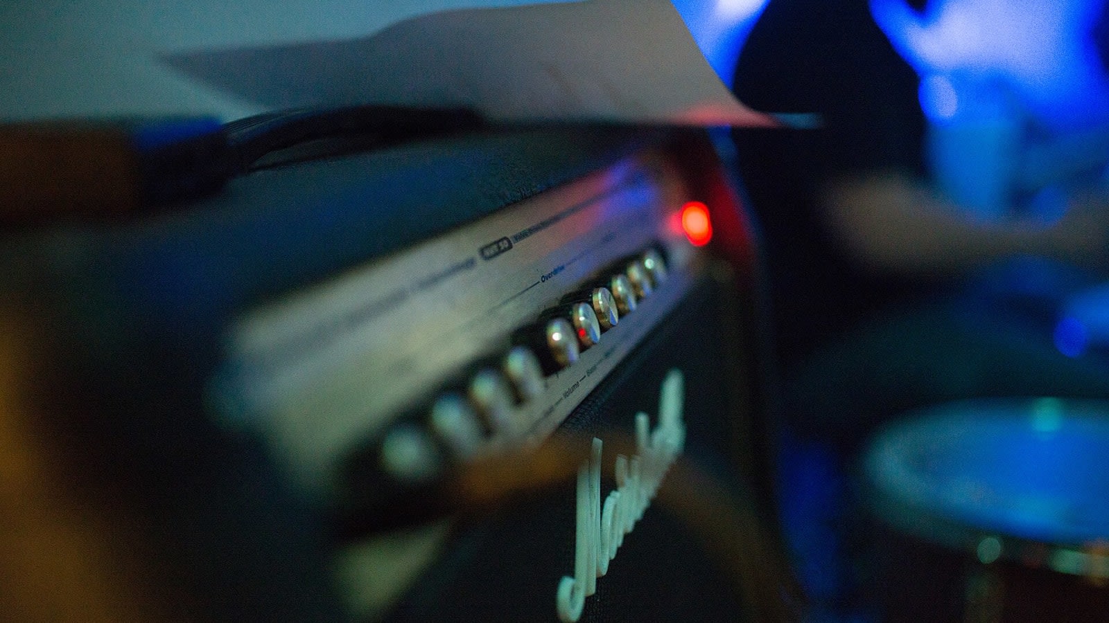 an electric guitar leaning against a stage amplifier (file image)