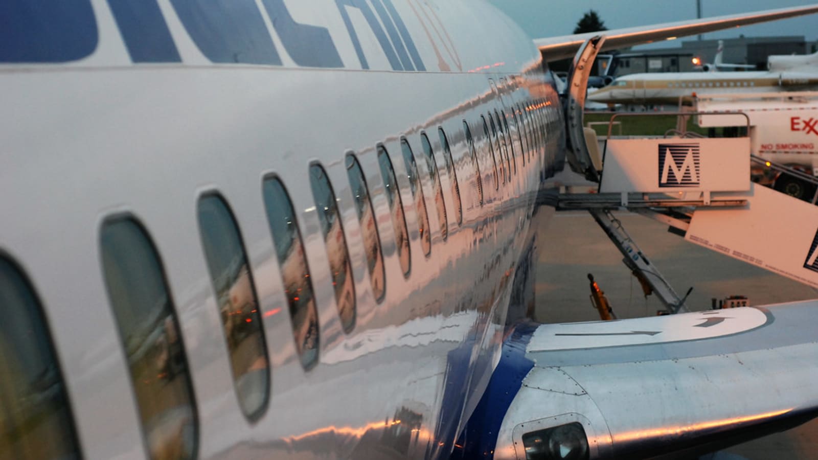 passenger aircraft parked on airport tarmac at dusk (file image)