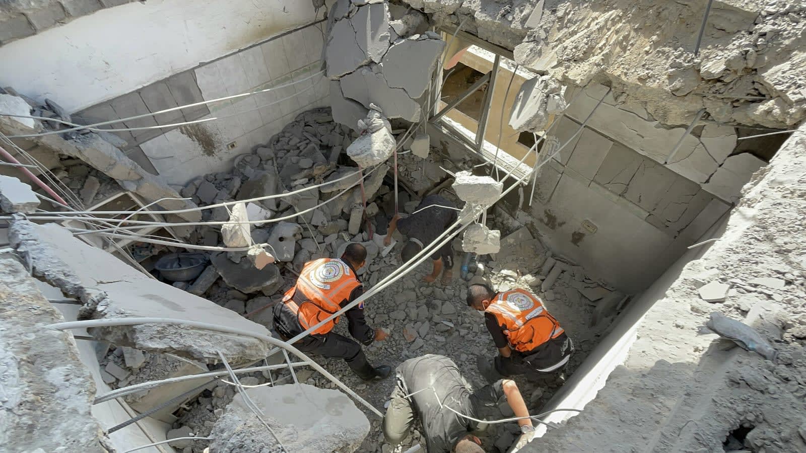 rescue workers searching through concrete rubble (file image)