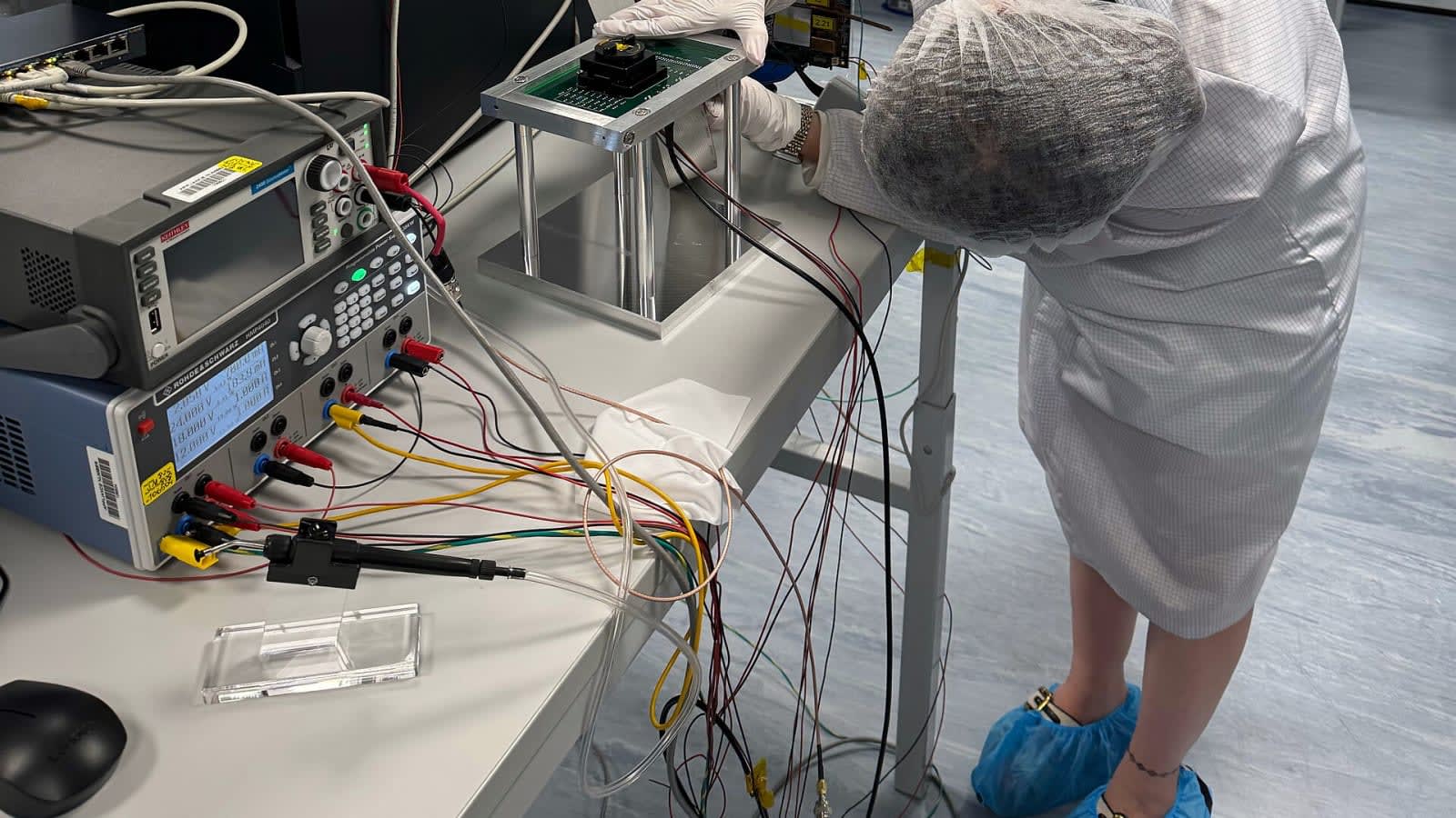 cleanroom technicians working on semiconductor wafers (file image)