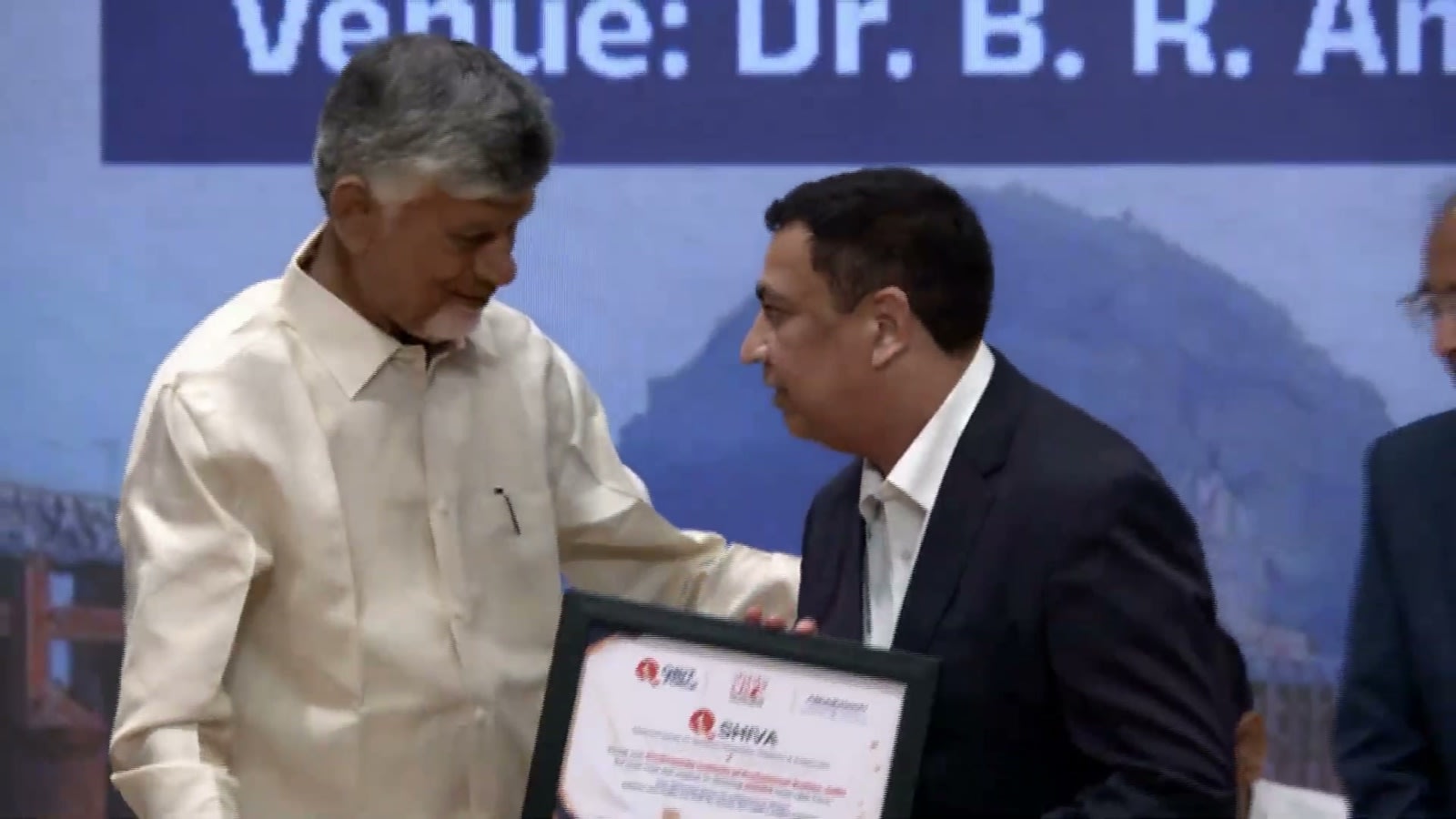 Chief Minister N Chandrababu Naidu hands over a QShiva certificate at the PanIIT Andhra Pradesh Summit