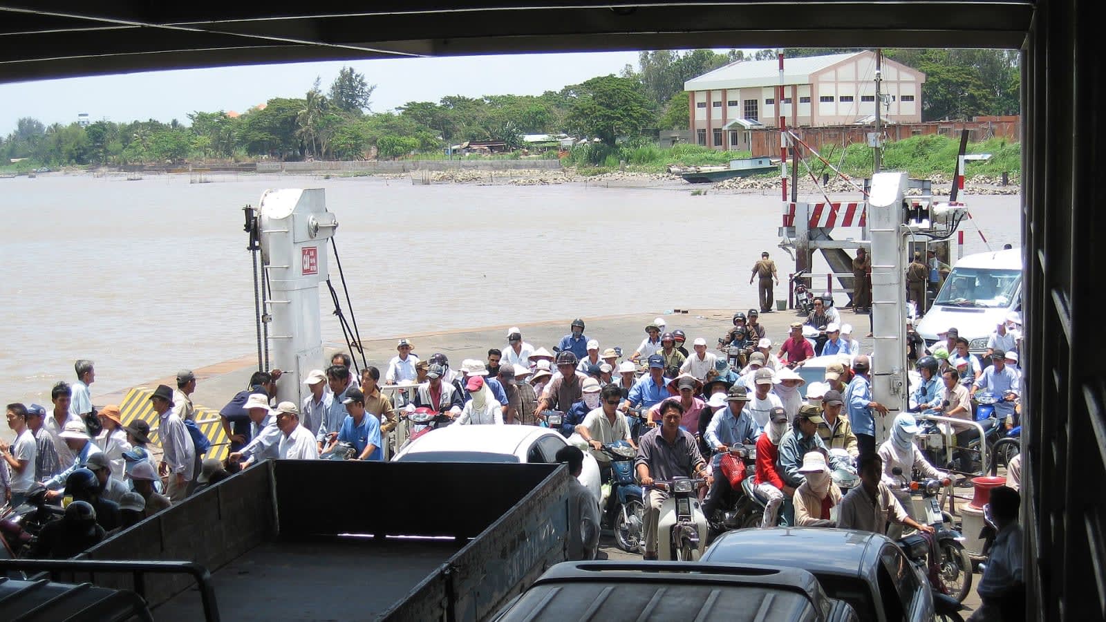 an electric passenger ferry docking at a modern terminal on a river (file image)