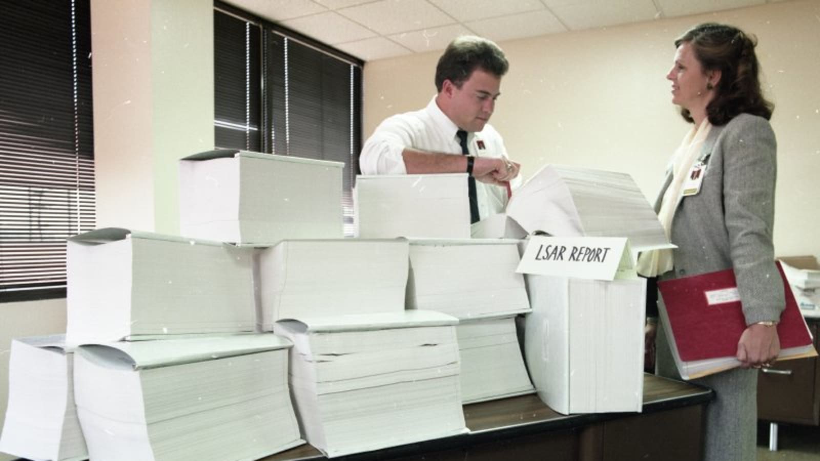 a student discussing documents with a lawyer in a modern office (file image)