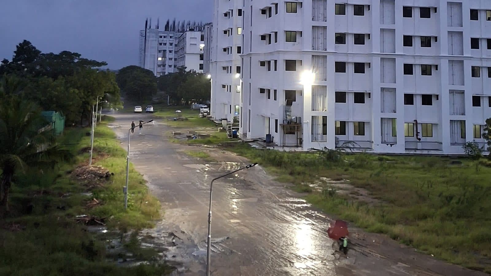 a neat, low-rise residential building campus surrounded by green trees in rural india (file image)