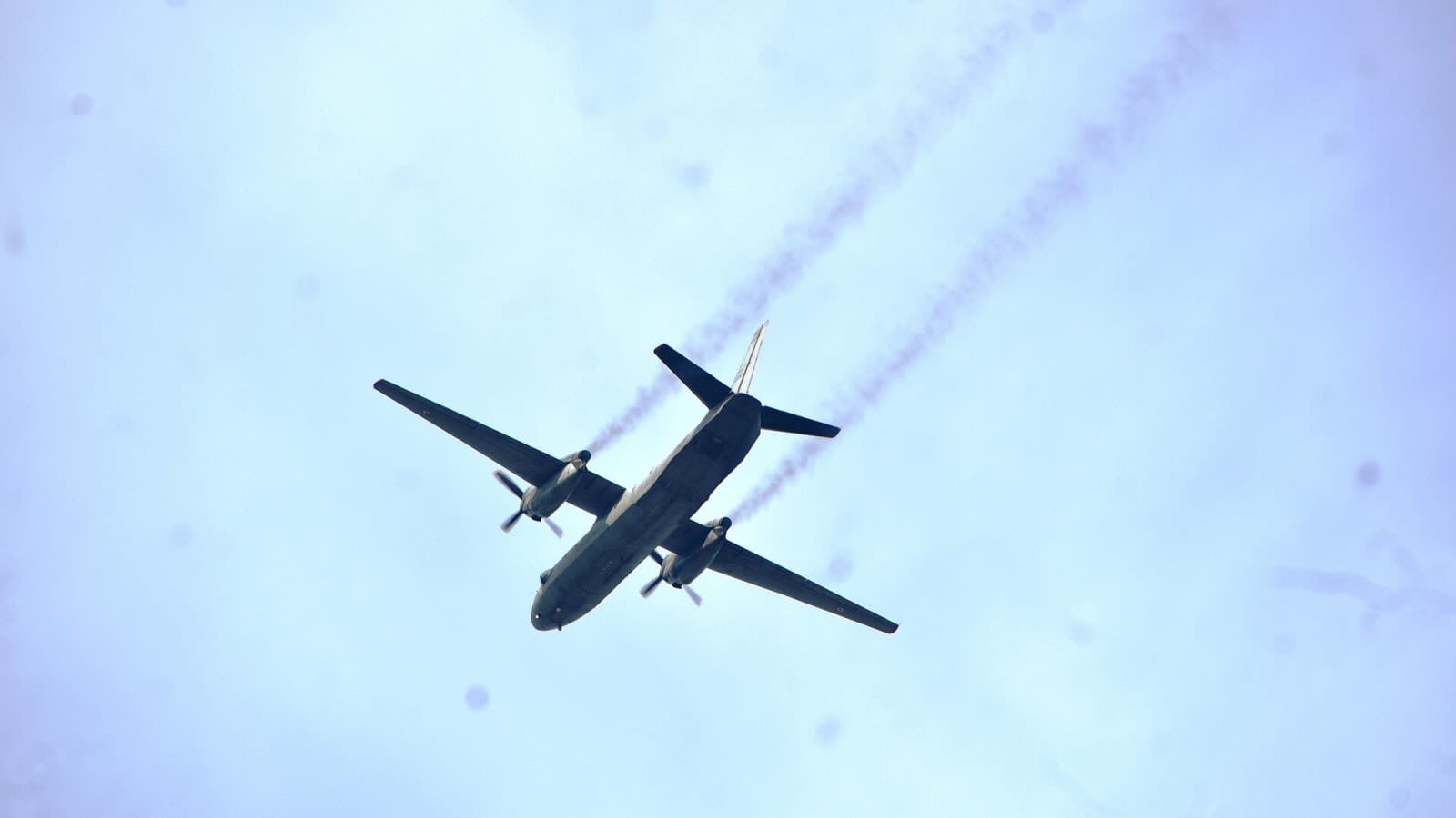 commercial jet airliner descending through clouds (file image)