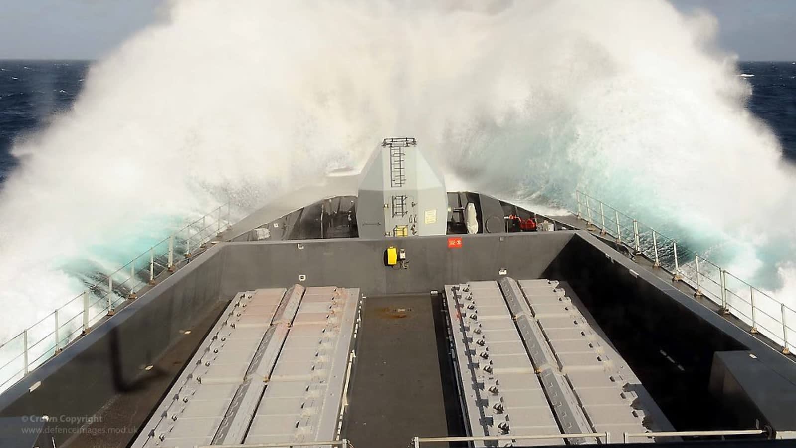 a grey naval ship patrolling open dark blue sea under a cloudy sky (file image)
