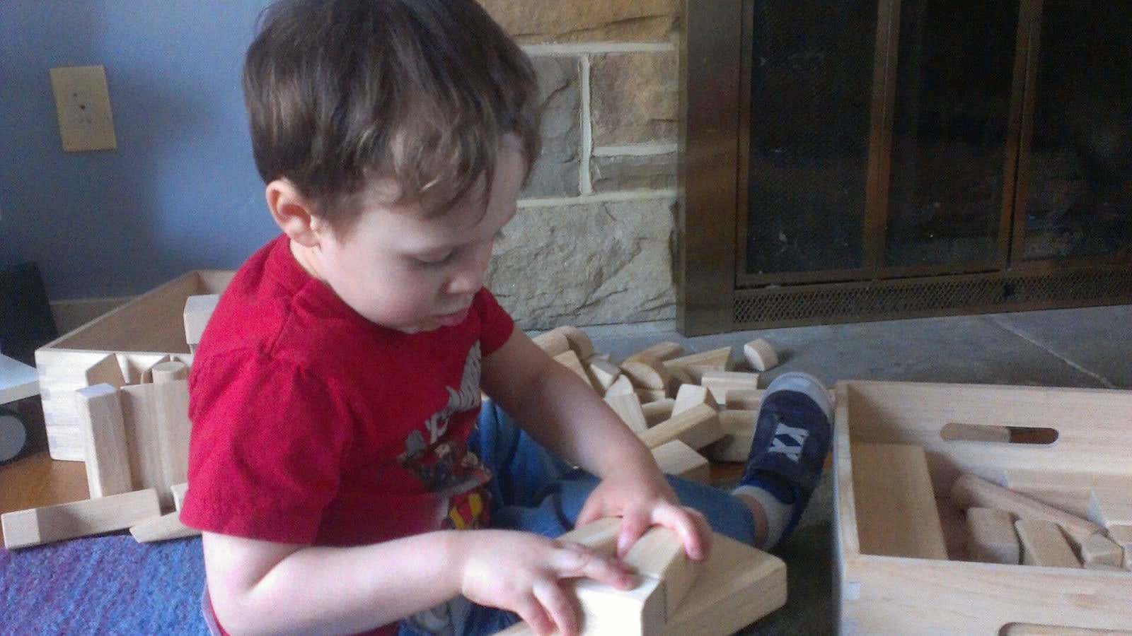 close up of a child playing with wooden blocks (file image)