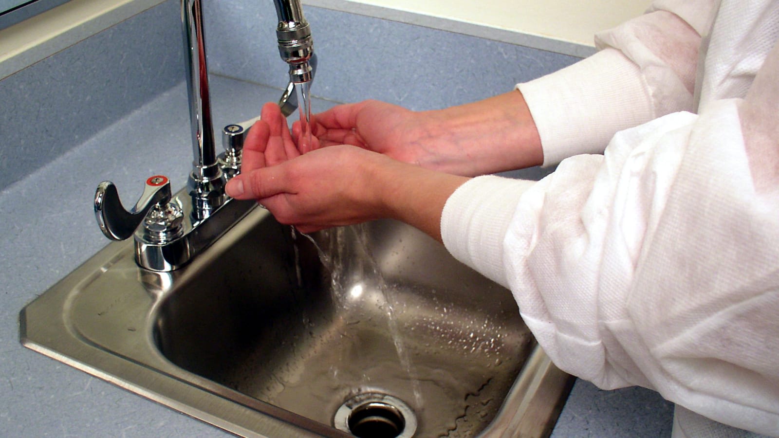 close up of a person washing their hands with soap and warm water at a sink (file image)