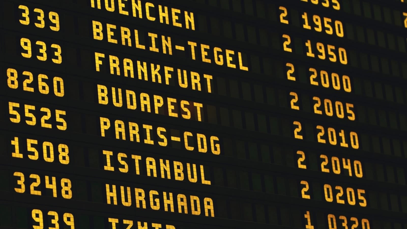 a crowded departures board in an airport terminal showing delayed and cancelled flights (file image)