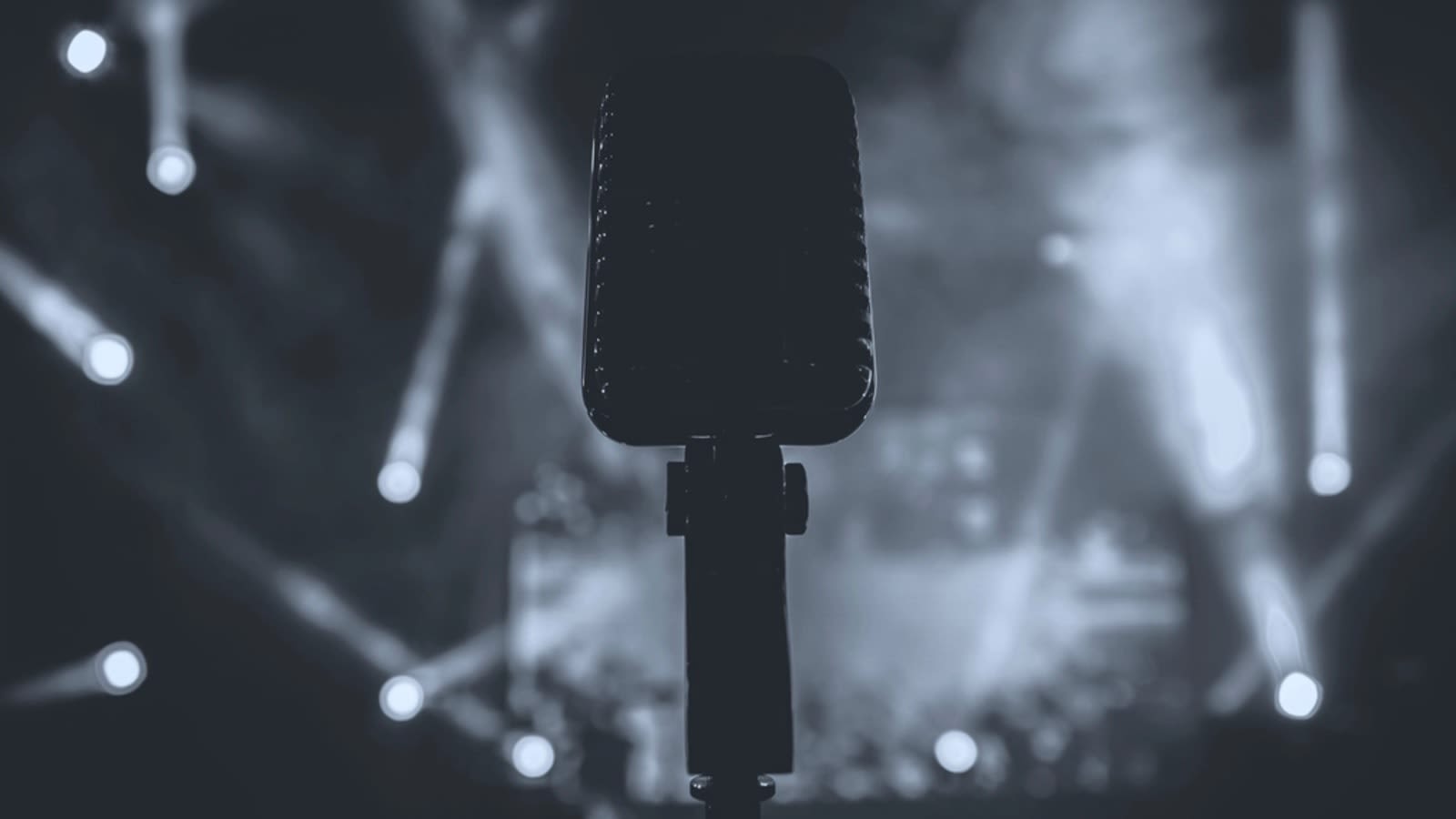low light concert venue stage with microphone stand (file image)