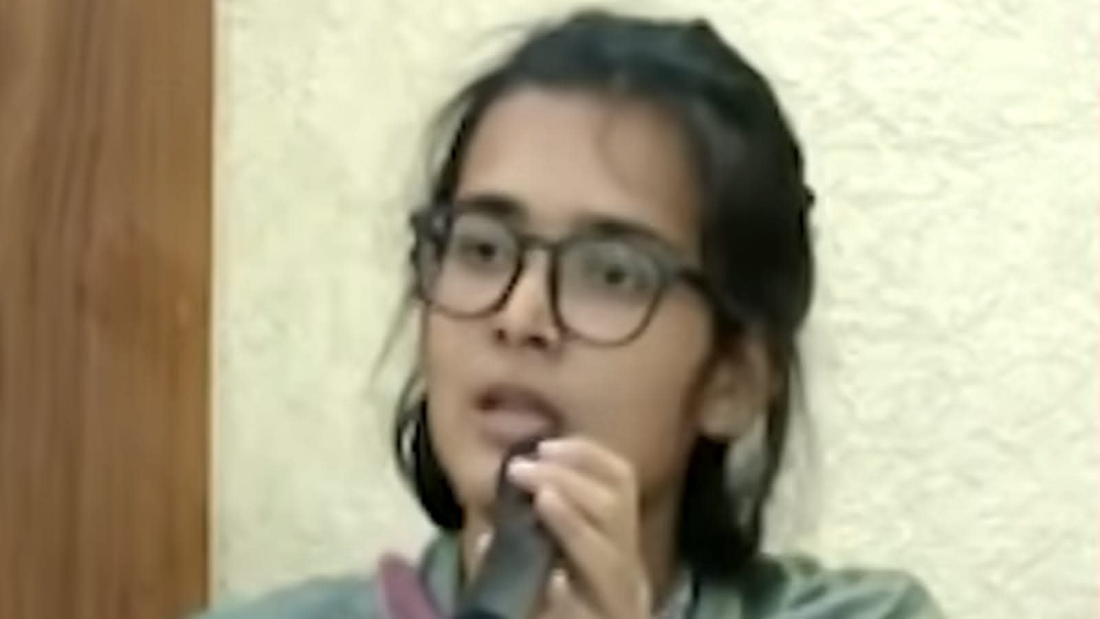 Neha Bora speaking at an event, central to the BJP’s remarks.