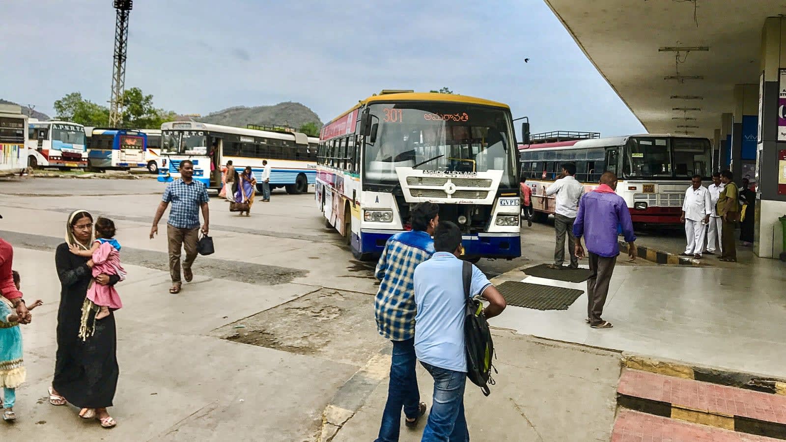 Passengers board APSRTC buses at Pandit Nehru Bus Station during Dasara rush.