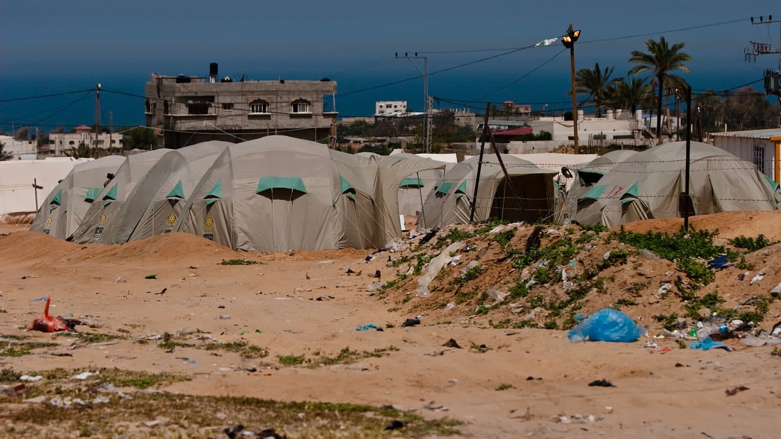 Displaced families in a Gaza Strip tent camp amid food aid cuts.