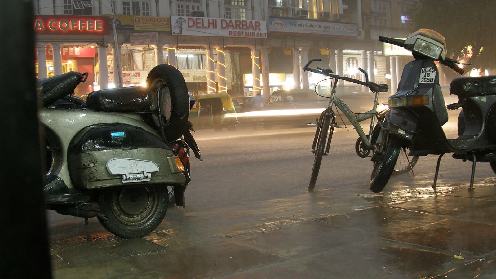 Delhi streets glisten under rain, easing pollution as storms pass.